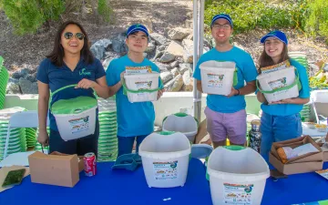 LASAN's organics team shows off the free countertop kitchen pails they're giving away at Earth Day LA